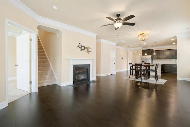 137 Golden Eagle Ln, Anderson, SC 29621 - living room with crown molding, ceiling fan, stairs, dark wood-style floors, and a fireplace with flush hearth