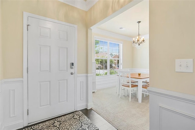 137 Golden Eagle Ln, Anderson, SC 29621 - foyer entrance featuring a chandelier, wainscoting, and crown molding