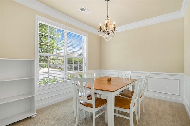 137 Golden Eagle Ln, Anderson, SC 29621 - dining space with a chandelier, light carpet, ornamental molding, plenty of natural light, and a wainscoted wall