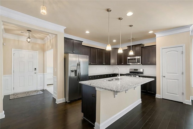 137 Golden Eagle Ln, Anderson, SC 29621 - kitchen featuring appliances with stainless steel finishes, dark brown cabinets, dark wood finished floors, an island with sink, and light stone countertops