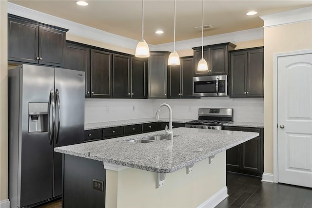 137 Golden Eagle Ln, Anderson, SC 29621 - kitchen with stainless steel appliances, light stone counters, dark wood finished floors, decorative light fixtures, and a center island with sink