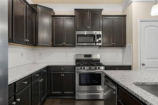 137 Golden Eagle Ln, Anderson, SC 29621 - kitchen featuring stainless steel appliances, crown molding, backsplash, light stone countertops, and dark wood-style floors
