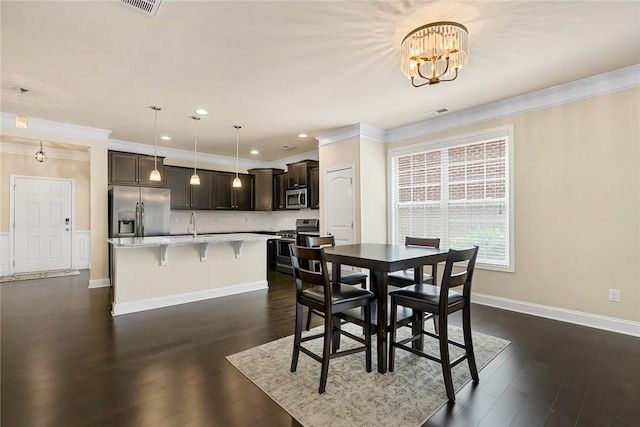 137 Golden Eagle Ln, Anderson, SC 29621 - dining room with crown molding, a chandelier, dark wood-style floors, and recessed lighting