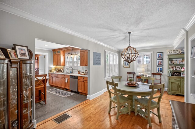 260 Riggs Dr, Clemson, SC 29631 - dining area with a chandelier, ornamental molding, a textured ceiling, and light wood-style flooring