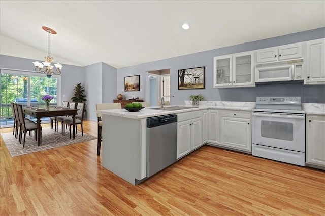 433 Shore Line Dr, Anderson, SC 29626 - kitchen featuring white appliances, a peninsula, a chandelier, vaulted ceiling, and light wood finished floors