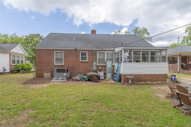 205 James St, Anderson, SC 29625 - rear view of property featuring a sunroom, brick siding, a lawn, and a chimney
