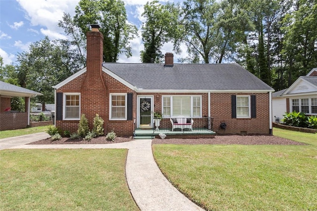205 James St, Anderson, SC 29625 - view of front of home with brick siding, a front lawn, a chimney, a porch, and a shingled roof