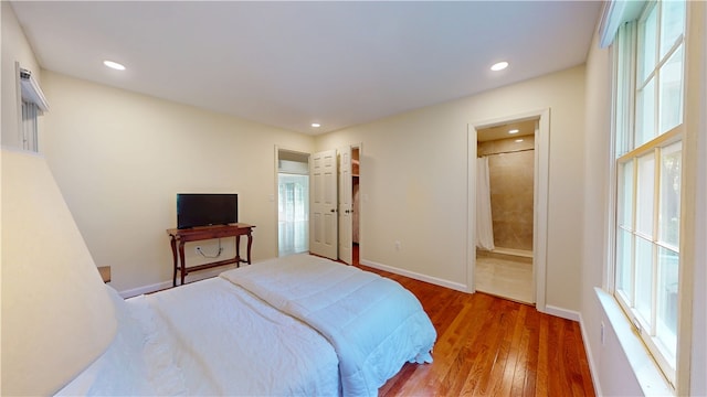 203 Ashley Rd, Clemson, SC 29631 - bedroom featuring wood finished floors, multiple windows, recessed lighting, and ensuite bathroom