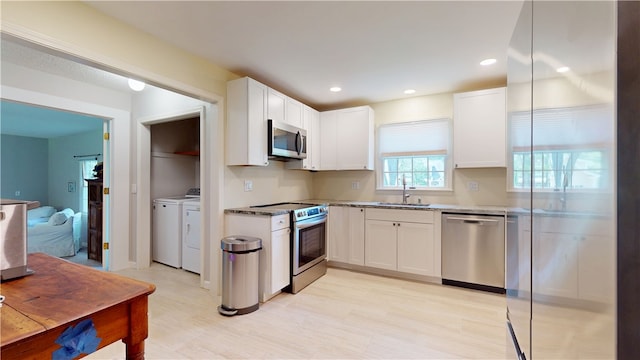 203 Ashley Rd, Clemson, SC 29631 - kitchen featuring stainless steel appliances, washer and clothes dryer, white cabinetry, light stone counters, and recessed lighting