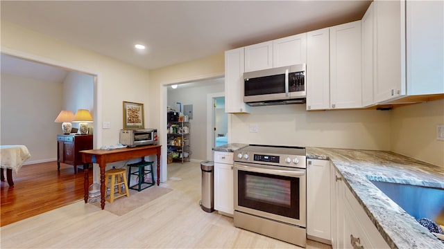 203 Ashley Rd, Clemson, SC 29631 - kitchen with stainless steel appliances, light wood-type flooring, white cabinets, light stone counters, and recessed lighting