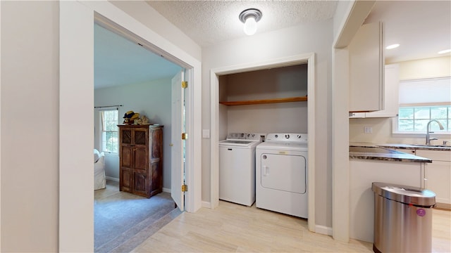 203 Ashley Rd, Clemson, SC 29631 - washroom with washer and dryer, light wood-style floors, and a textured ceiling