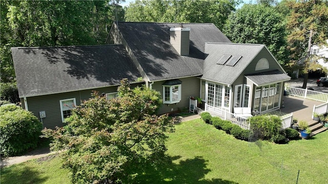 203 Ashley Rd, Clemson, SC 29631 - back of house featuring a chimney, a sunroom, a wooden deck, a lawn, and roof with shingles