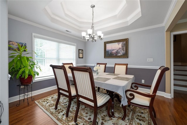 1339 Griffin Mill Rd, Easley, SC 29640 - dining area featuring a chandelier, a tray ceiling, wood finished floors, and ornamental molding
