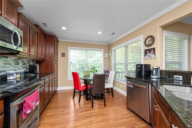 1339 Griffin Mill Rd, Easley, SC 29640 - kitchen with appliances with stainless steel finishes, plenty of natural light, light wood-type flooring, decorative backsplash, and recessed lighting