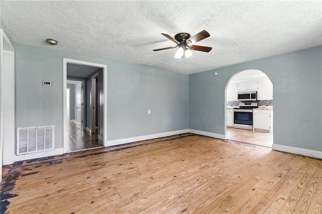 159 Rabbit Rd, Pickens, SC 29671 - empty room featuring ceiling fan, arched walkways, light wood-type flooring, a textured ceiling, and a smoke detector