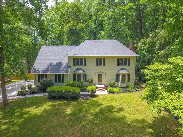 111 Halifax Rd, Easley, SC 29642 - colonial-style house with a chimney, a front yard, and a shingled roof