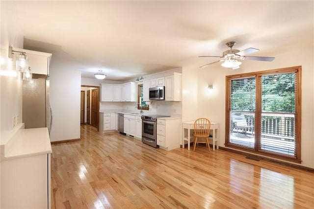 111 Halifax Rd, Easley, SC 29642 - kitchen featuring appliances with stainless steel finishes, light wood-type flooring, white cabinetry, ceiling fan, and light countertops