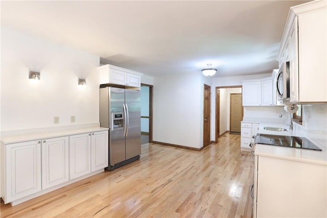 111 Halifax Rd, Easley, SC 29642 - kitchen with appliances with stainless steel finishes, light wood-style flooring, white cabinetry, and light countertops