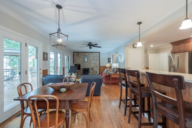 227 E Clearwater Shores Rd, Fair Play, SC 29643 - dining space with a ceiling fan, ornamental molding, light wood finished floors, and a stone fireplace