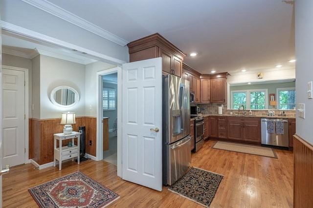 227 E Clearwater Shores Rd, Fair Play, SC 29643 - kitchen featuring appliances with stainless steel finishes, light wood-style flooring, a wainscoted wall, ornamental molding, and backsplash