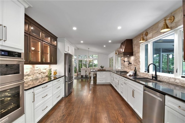 36 Mizzen Ln, Salem, SC 29676 - kitchen with appliances with stainless steel finishes, decorative backsplash, vaulted ceiling, custom exhaust hood, and glass insert cabinets