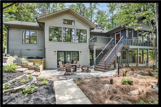 36 Mizzen Ln, Salem, SC 29676 - rear view of property featuring a sunroom, a patio area, stairway, a deck, and a chimney