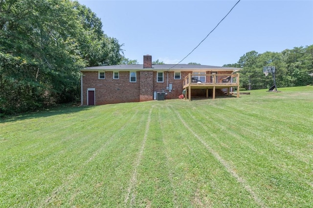 208 Springview Dr, Anderson, SC 29625 - rear view of house with a chimney, brick siding, a yard, and a wooden deck
