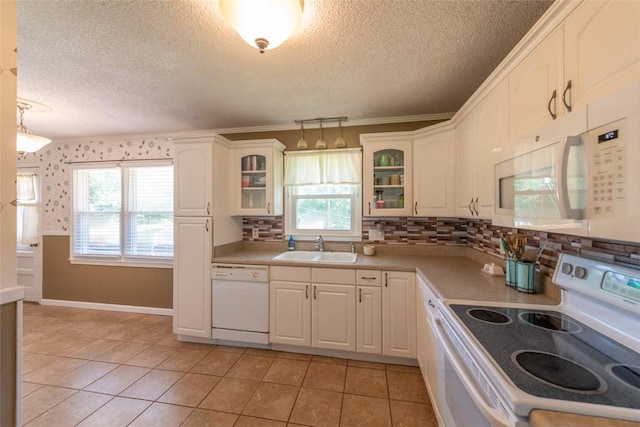208 Springview Dr, Anderson, SC 29625 - kitchen featuring white appliances, a textured ceiling, glass insert cabinets, white cabinetry, and light tile patterned flooring