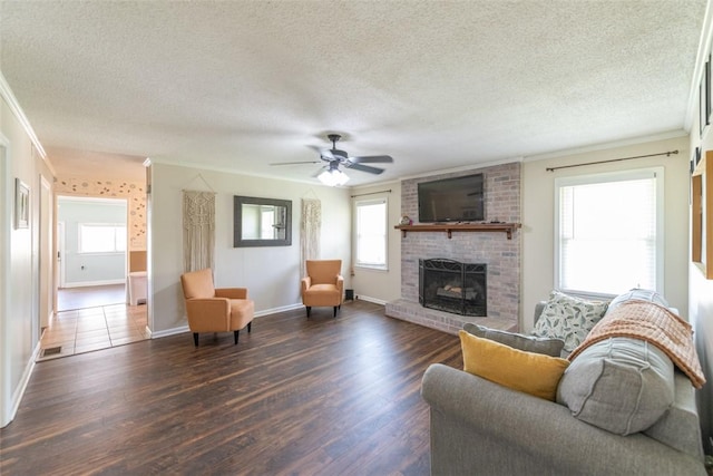 208 Springview Dr, Anderson, SC 29625 - living room with a textured ceiling, crown molding, a fireplace, dark wood finished floors, and ceiling fan