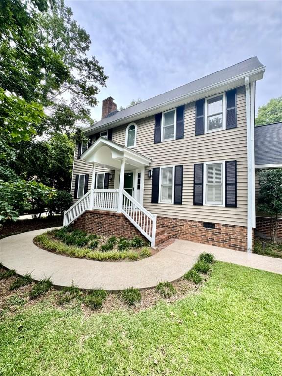 203 Catawbah Rd, Clemson, SC 29631 - view of front of house with a chimney, a front yard, and crawl space
