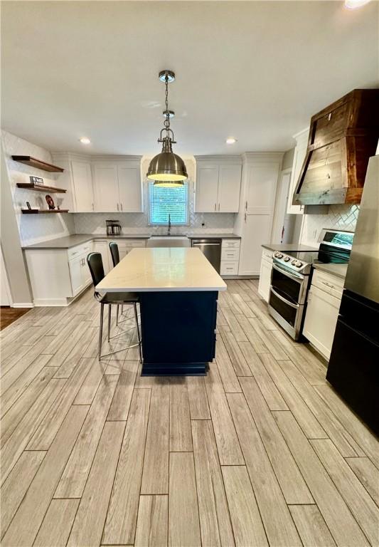 203 Catawbah Rd, Clemson, SC 29631 - kitchen with stainless steel appliances, light wood finished floors, light countertops, backsplash, and recessed lighting