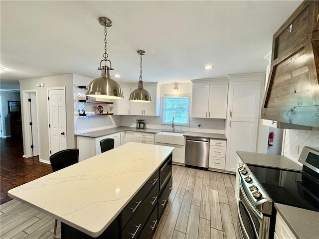 203 Catawbah Rd, Clemson, SC 29631 - kitchen with appliances with stainless steel finishes, light wood-type flooring, white cabinets, backsplash, and recessed lighting