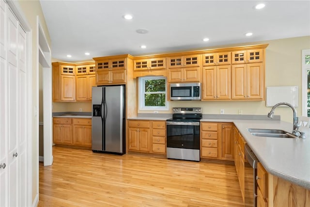 223 Inlet Pointe Dr, Anderson, SC 29625 - kitchen featuring appliances with stainless steel finishes, light wood-type flooring, recessed lighting, light countertops, and glass insert cabinets