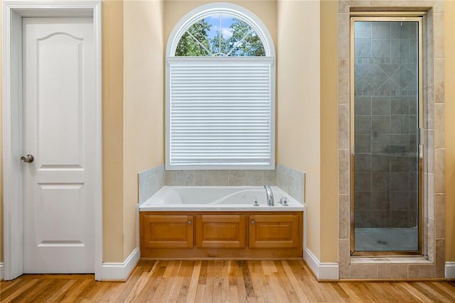 223 Inlet Pointe Dr, Anderson, SC 29625 - bathroom with wood finished floors, a stall shower, and a bath