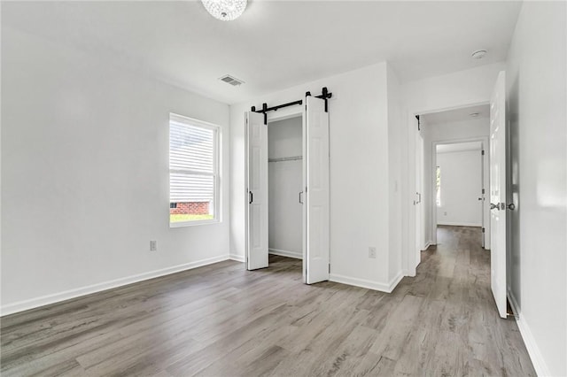 1938 Inman Dr, Anderson, SC 29625 - unfurnished bedroom featuring wood finished floors and a barn door