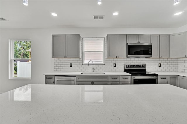 1938 Inman Dr, Anderson, SC 29625 - kitchen with stainless steel appliances, gray cabinetry, tasteful backsplash, and recessed lighting