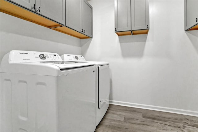 1938 Inman Dr, Anderson, SC 29625 - laundry room featuring cabinet space, washer and dryer, and wood finished floors