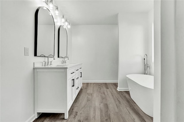 1938 Inman Dr, Anderson, SC 29625 - bathroom featuring double vanity, wood finished floors, and a soaking tub