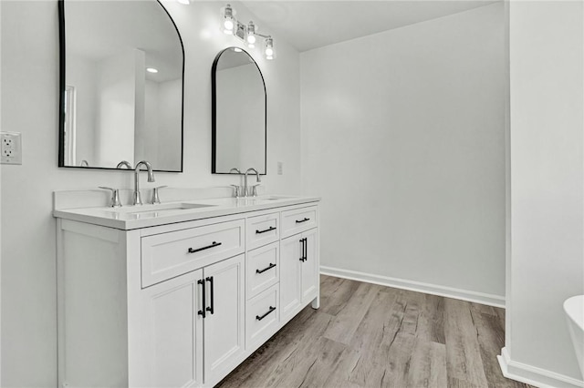 1938 Inman Dr, Anderson, SC 29625 - full bathroom featuring double vanity, wood finished floors, and a freestanding bath