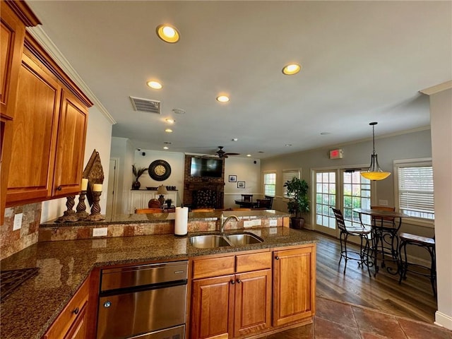 209 Calhoun St Unit 402, Clemson, SC 29631 - kitchen with brown cabinets, crown molding, recessed lighting, a ceiling fan, and a peninsula