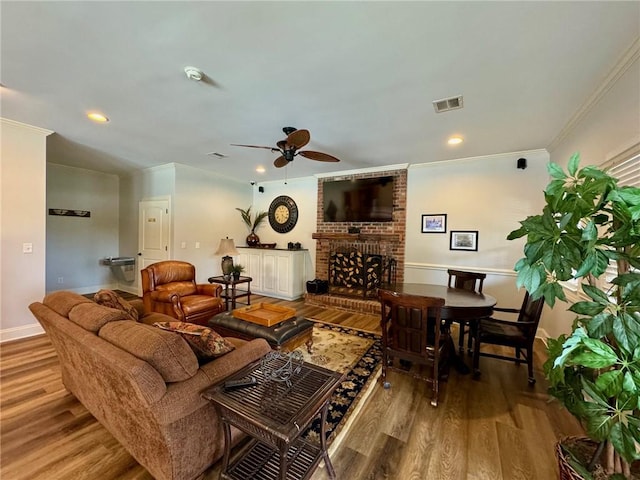 209 Calhoun St Unit 402, Clemson, SC 29631 - living room featuring wood finished floors, a fireplace, a ceiling fan, ornamental molding, and recessed lighting