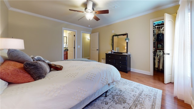 209 Calhoun St Unit 402, Clemson, SC 29631 - bedroom with a spacious closet, wood finished floors, ornamental molding, a closet, and ceiling fan