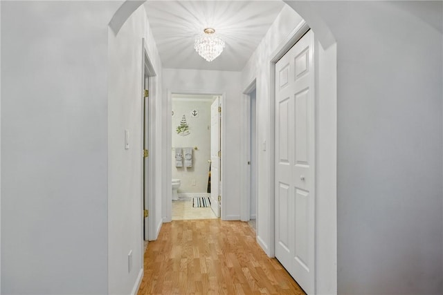 101 Jocassee Falls Rd, Salem, SC 29676 - hall with arched walkways, light wood-style floors, and a chandelier