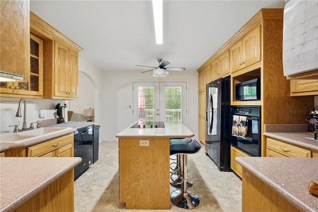 101 Jocassee Falls Rd, Salem, SC 29676 - kitchen featuring black appliances, a kitchen island, a kitchen bar, glass insert cabinets, and arched walkways