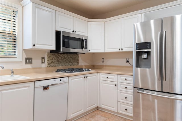 537 Sullivans Way, Seneca, SC 29678 - kitchen with appliances with stainless steel finishes, white cabinets, light countertops, light tile patterned flooring, and backsplash