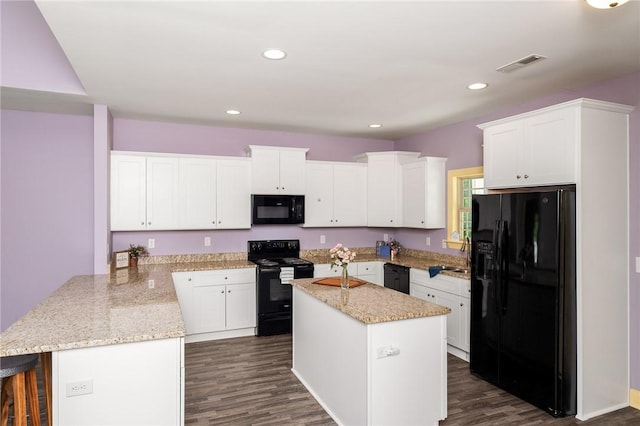 128 Willys Creek Cir, Pickens, SC 29671 - kitchen with black appliances, a peninsula, white cabinetry, dark wood-style flooring, and recessed lighting