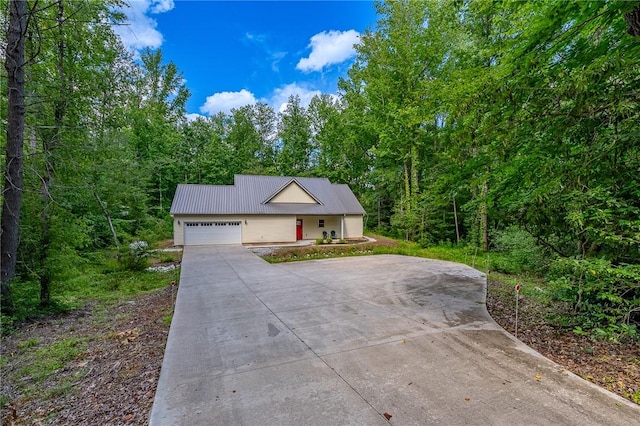 128 Willys Creek Cir, Pickens, SC 29671 - view of front of property featuring a garage, driveway, a wooded view, and a metal roof