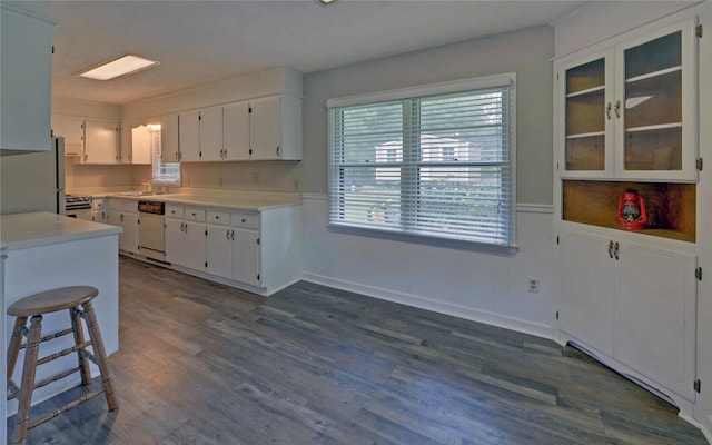 37 Cunningham Dr, Hartwell, GA 30643 - kitchen featuring dishwasher, white cabinetry, light countertops, dark wood-type flooring, and a wainscoted wall
