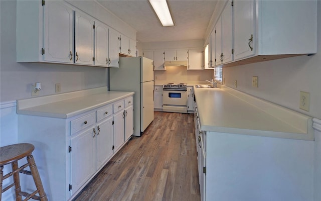 37 Cunningham Dr, Hartwell, GA 30643 - kitchen featuring stainless steel range, white cabinetry, wood finished floors, freestanding refrigerator, and light countertops