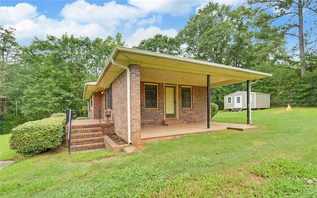 37 Cunningham Dr, Hartwell, GA 30643 - back of house featuring a lawn, brick siding, a storage shed, and a porch